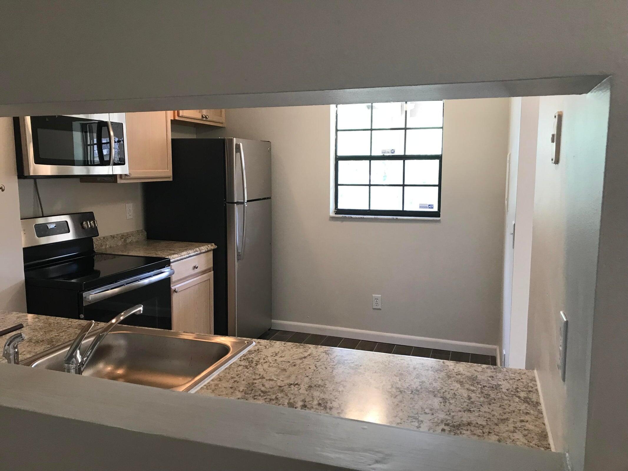 3629 Northwest 94th Avenue, Unit G5 Sunrise, FL 33351 - Photo 3 of 9 a bedroom with a bed and a window