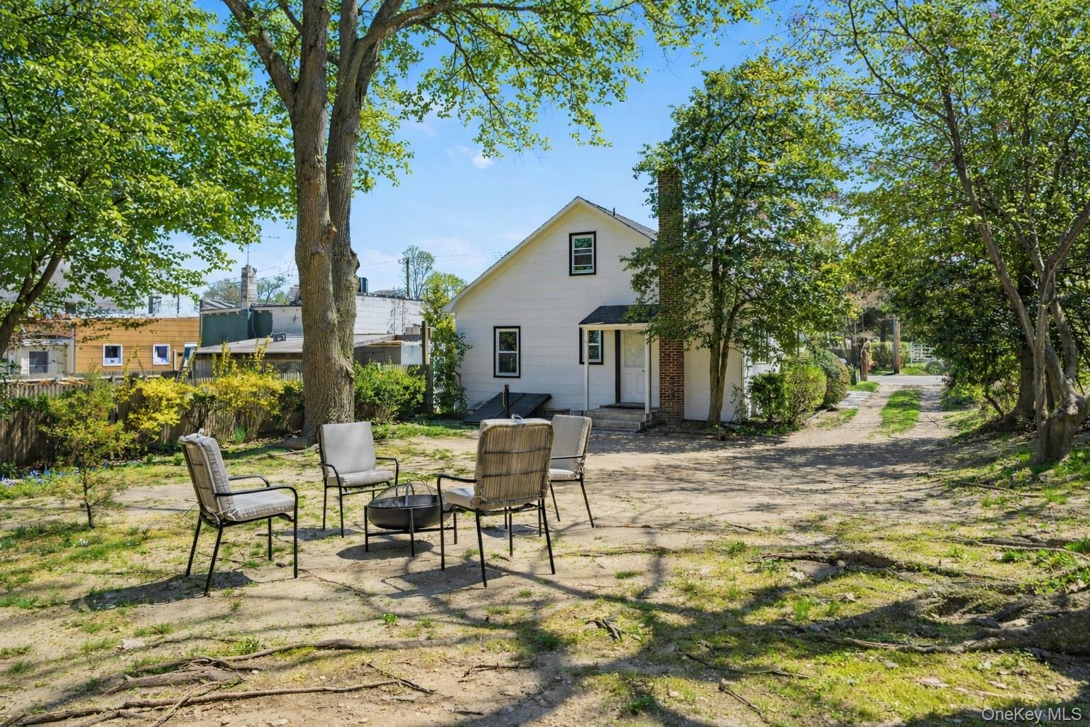 1550 Main Road Riverhead, NY 11901 - Photo 21 of 28 Natural outdoor setting featuring a mature tree, surrounding foliage, and a cleared area