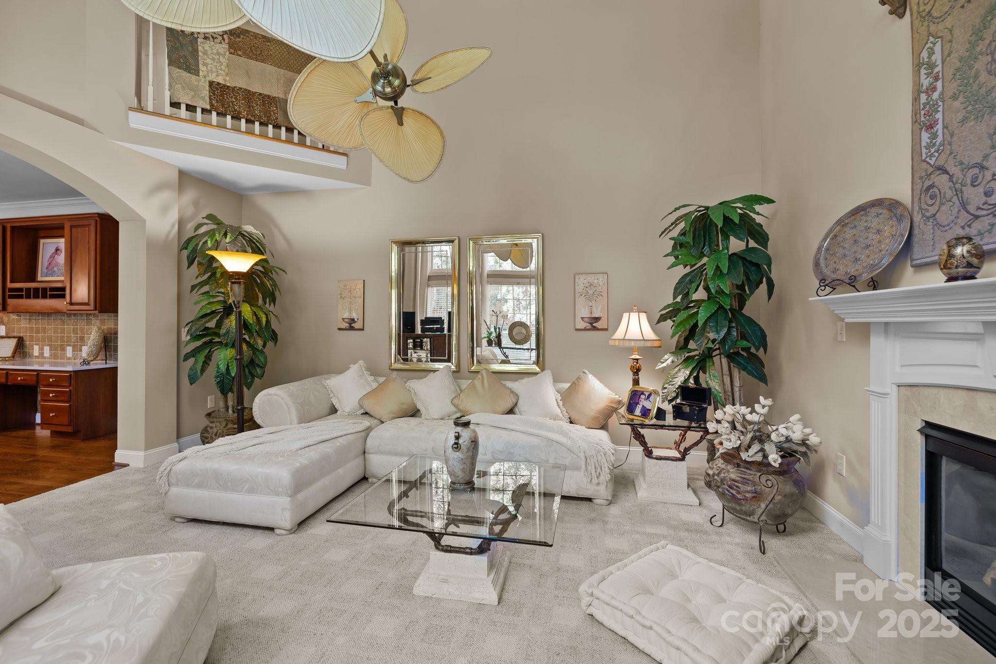 204 Limerick Drive Matthews, NC 28104 - Photo 14 of 44 a living room with furniture a fireplace and a potted plant