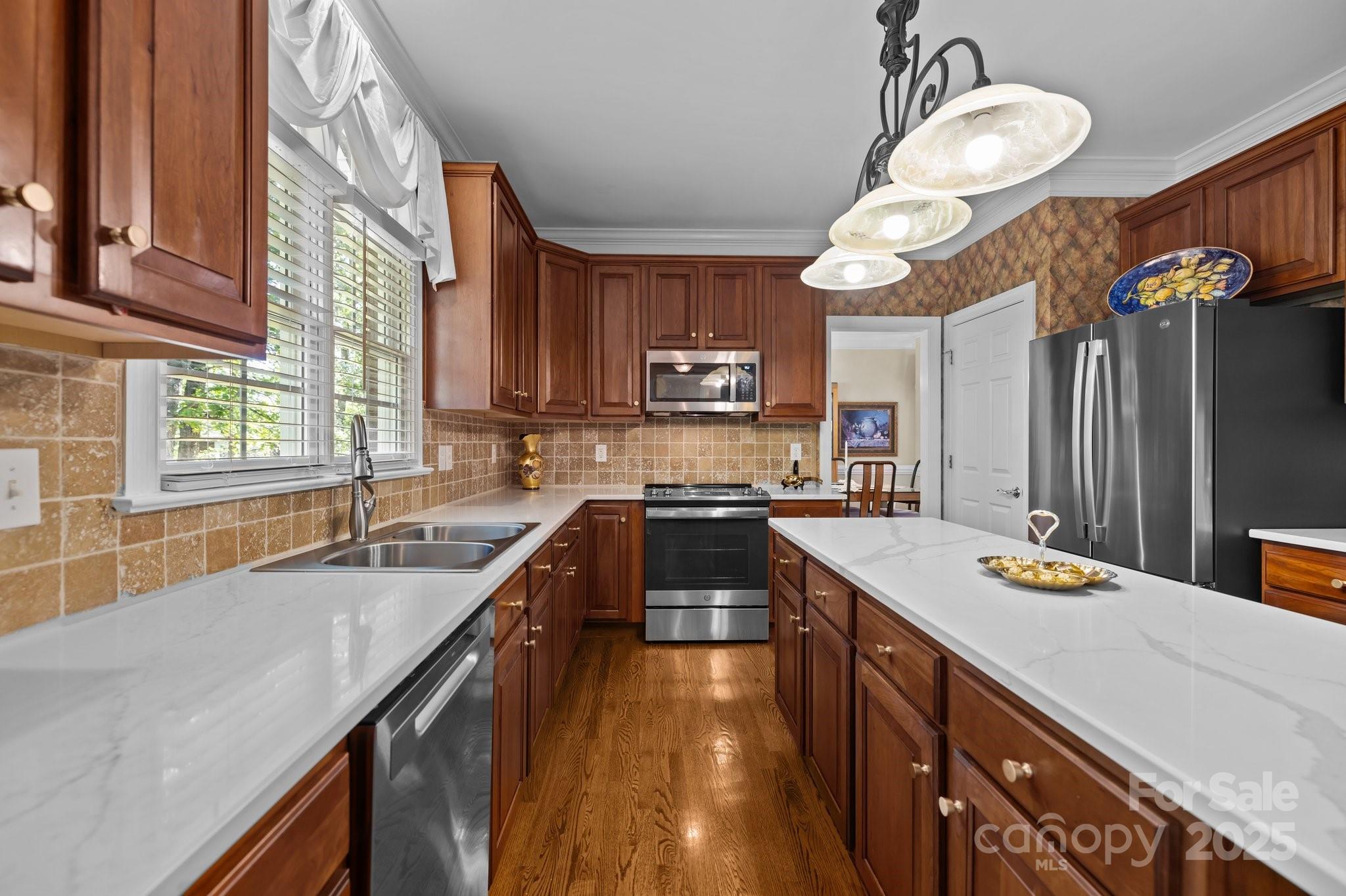 204 Limerick Drive Matthews, NC 28104 - Photo 15 of 44 a kitchen with a sink a counter space appliances and cabinets