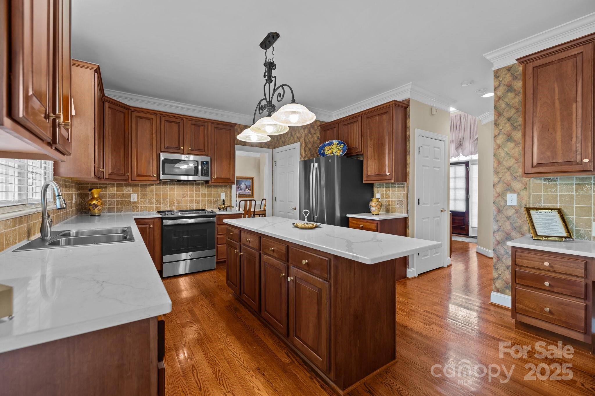 204 Limerick Drive Matthews, NC 28104 - Photo 16 of 44 a kitchen with stainless steel appliances granite countertop wooden cabinets a stove top oven a sink and dishwasher