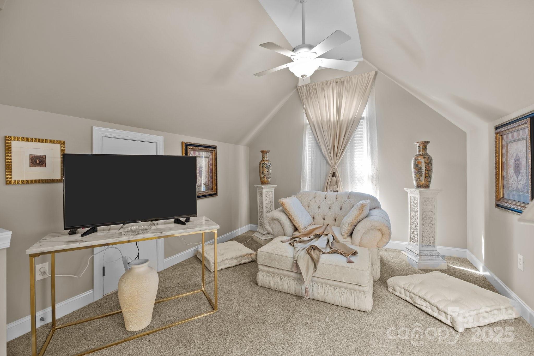 204 Limerick Drive Matthews, NC 28104 - Photo 24 of 44 a living room with furniture a flat screen tv and a chandelier