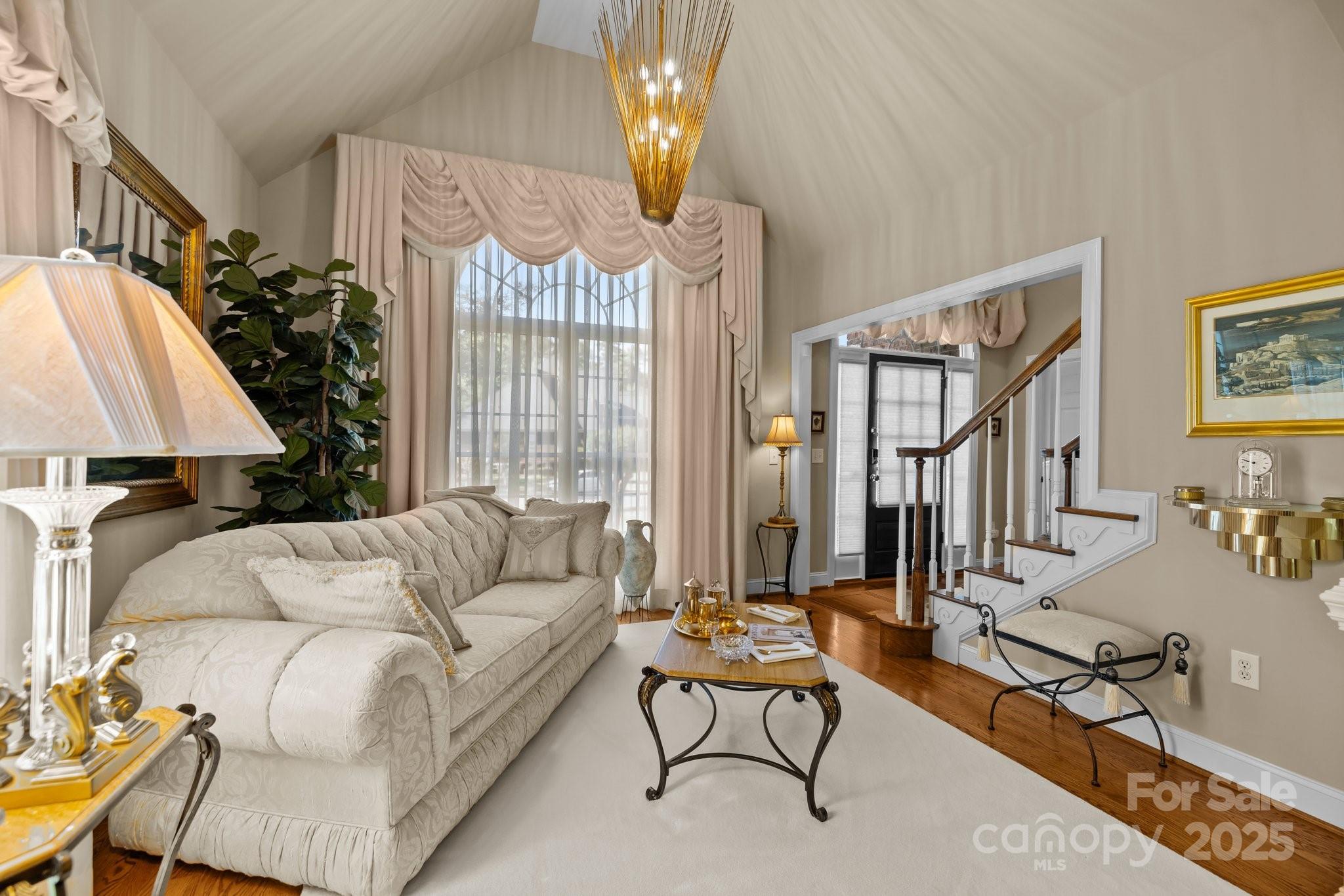204 Limerick Drive Matthews, NC 28104 - Photo 10 of 44 a living room with furniture fireplace and a chandelier