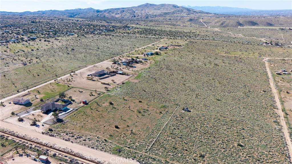 9588 Milpas Road Apple Valley, CA 92308 - Photo 15 of 22 a view of a backyard with mountain view