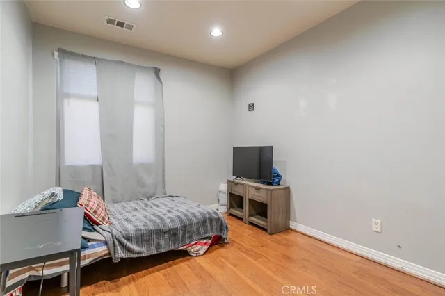 a bedroom with a bed and a television