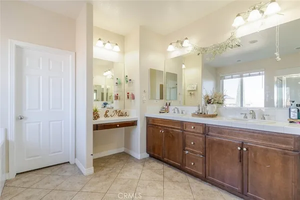 a spacious bathroom with a granite countertop sink and mirror