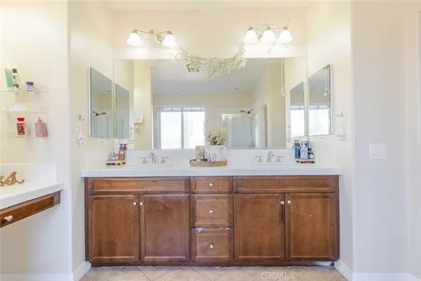 a en suite bathroom with a sink double vanity and a mirror