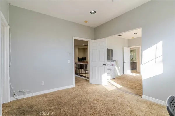 a view of a big room with closet and windows