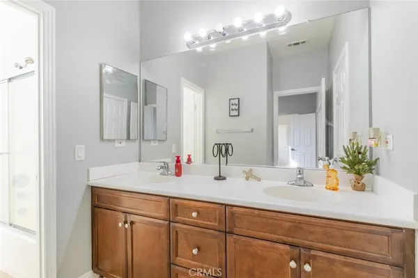 a bathroom with a sink double vanity and a mirror