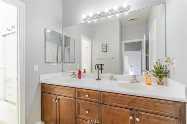 a bathroom with a sink double vanity and a mirror