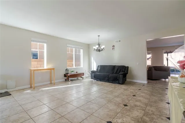 a living room with furniture and a dining table with wooden floor