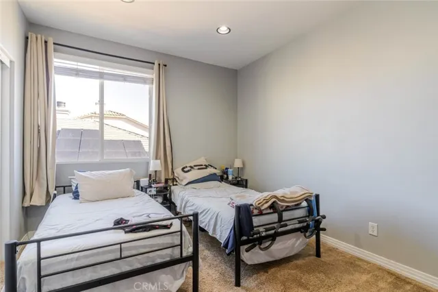 a bedroom with bed and a window