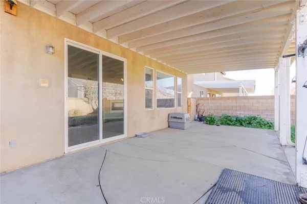 a view of a house with backyard sitting area and garden