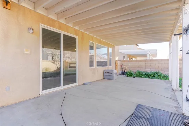 a view of a house with backyard sitting area and garden