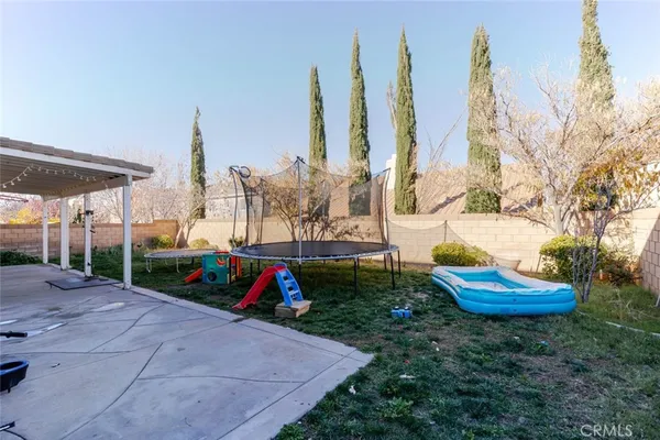 an aerial view of a city with lots of residential buildings and ocean view in back