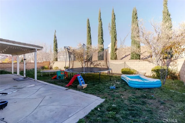 an aerial view of a city with lots of residential buildings and ocean view in back
