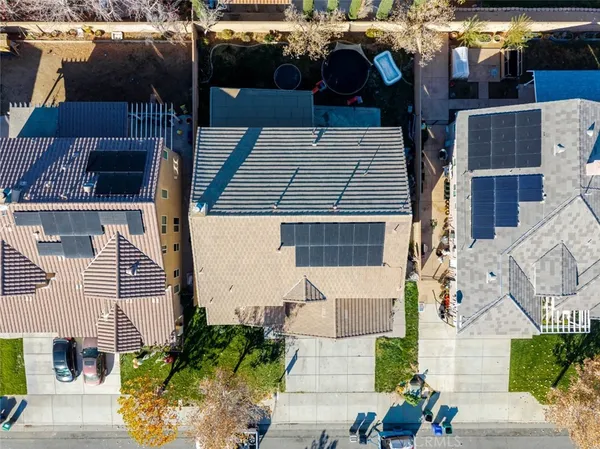 an aerial view of a house with swimming pool and ocean view
