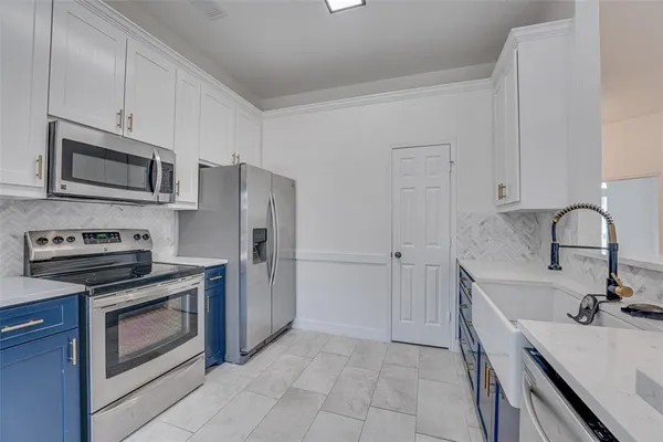 a kitchen with a sink stove and refrigerator