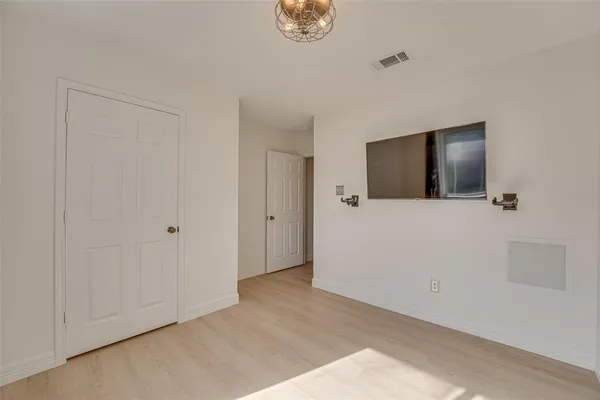 a view of empty room with floor and fan