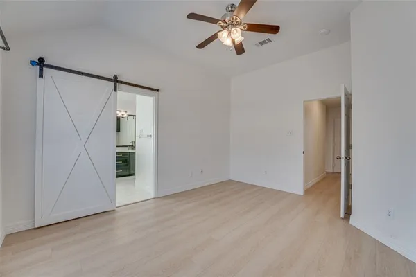 an empty room with a chandelier fan