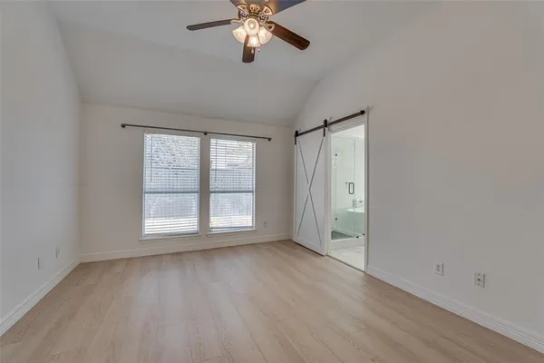 a bathroom with a tub shower sink and mirror