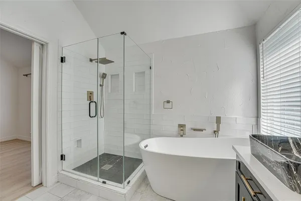 a bathroom with a bathtub and shower