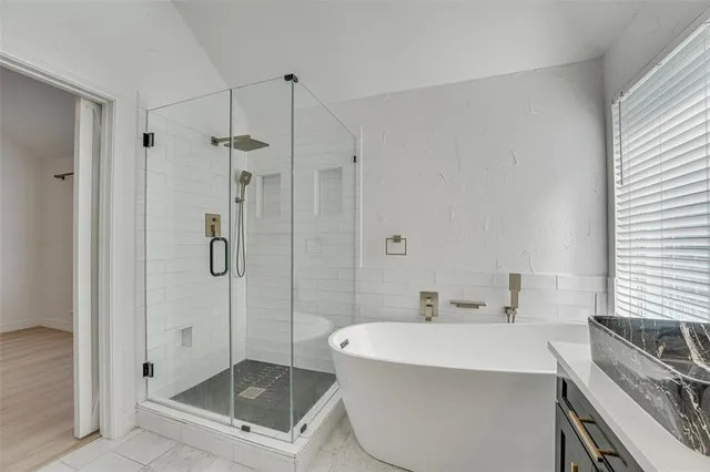 a bathroom with a bathtub and shower
