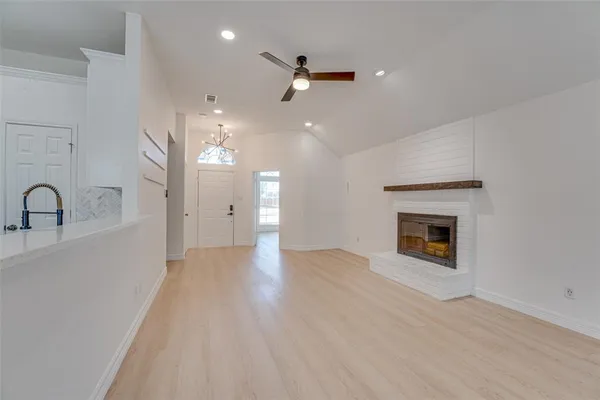 a view of a livingroom with a fireplace and wooden floor