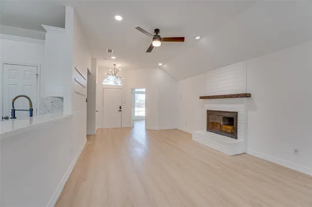 a view of a livingroom with a fireplace and wooden floor
