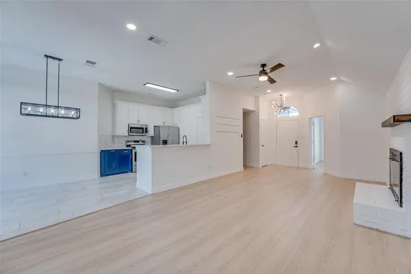 a view of kitchen with refrigerator and window