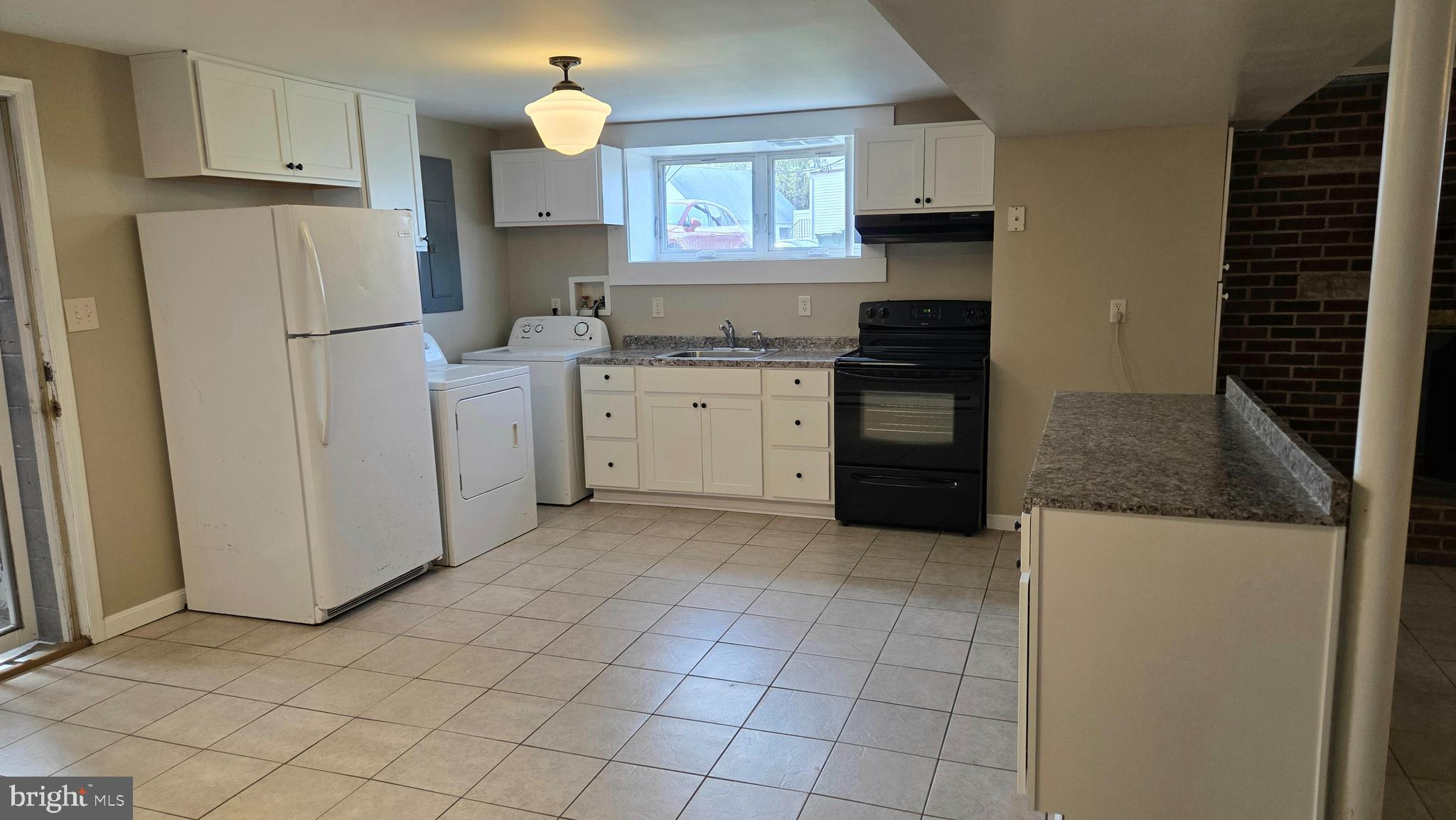 4400 4th Street Baltimore, MD 21225 - Photo 5 of 25 a kitchen with a refrigerator stove and cabinets