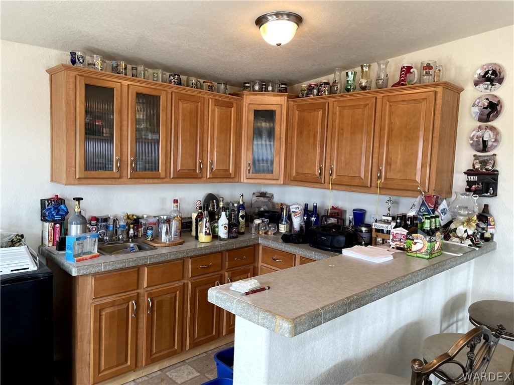 10551 East Blake Ranch Road Kingman, AZ 86401 - Photo 11 of 50 a kitchen with a sink and cabinets