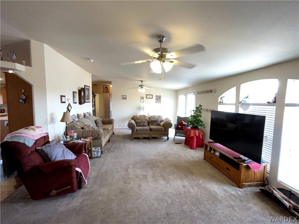 10551 East Blake Ranch Road Kingman, AZ 86401 - Photo 12 of 50 a living room with furniture and a flat screen tv