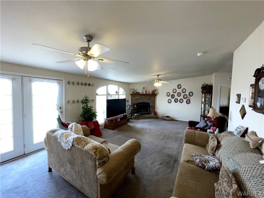 10551 East Blake Ranch Road Kingman, AZ 86401 - Photo 13 of 50 a living room with furniture and a flat screen tv