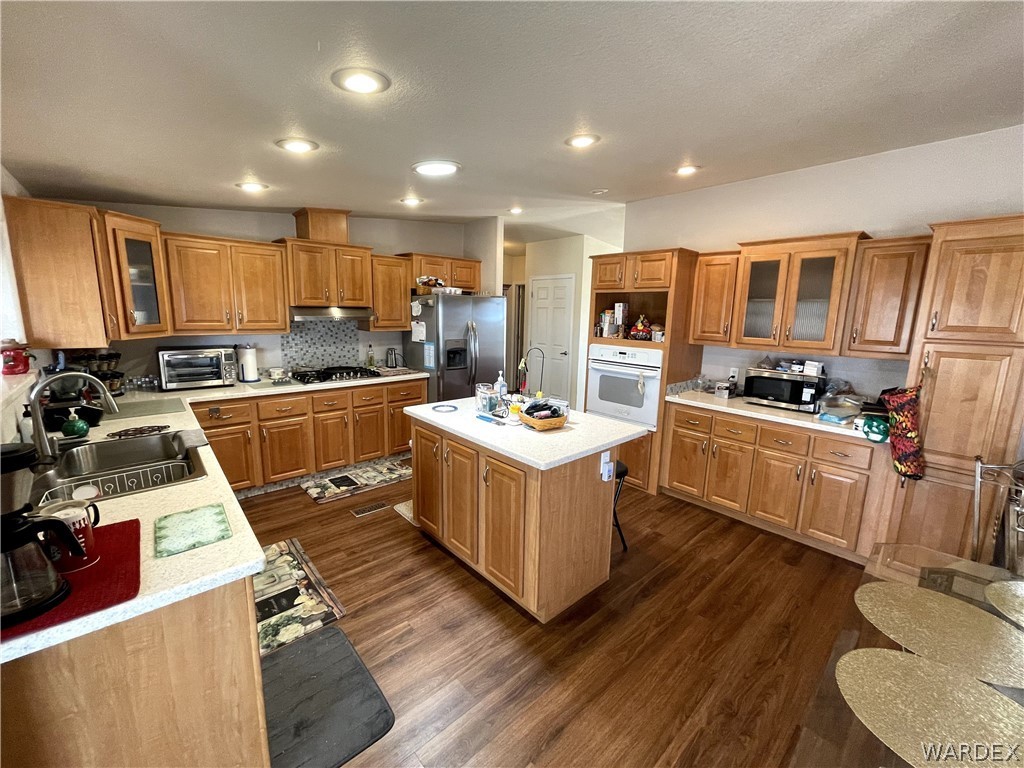 10551 East Blake Ranch Road Kingman, AZ 86401 - Photo 2 of 50 a kitchen with a sink stove cabinets and refrigerator
