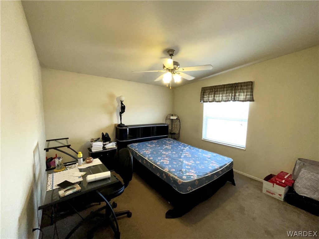 10551 East Blake Ranch Road Kingman, AZ 86401 - Photo 22 of 50 a bedroom with bed and window