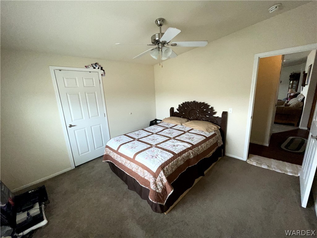 10551 East Blake Ranch Road Kingman, AZ 86401 - Photo 24 of 50 a bedroom with a bed and a flat tv screen on the dresser
