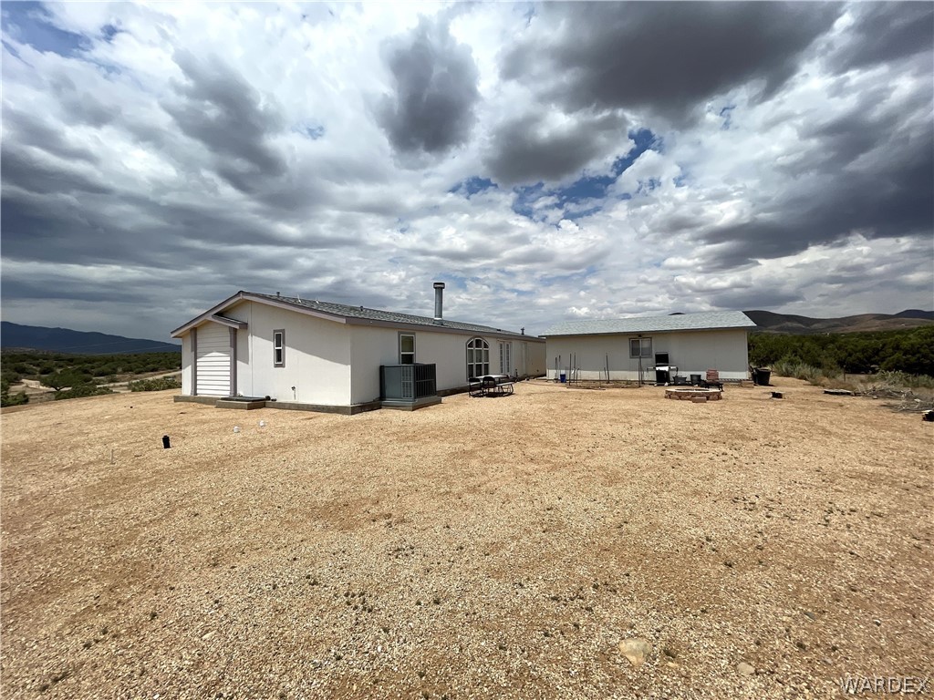 10551 East Blake Ranch Road Kingman, AZ 86401 - Photo 33 of 50 a view of a house with a yard and garage