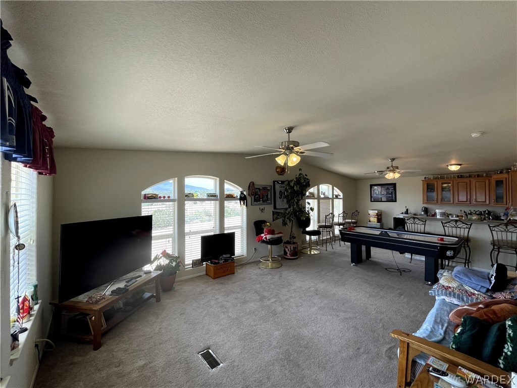 10551 East Blake Ranch Road Kingman, AZ 86401 - Photo 7 of 50 a living room with furniture and a flat screen tv