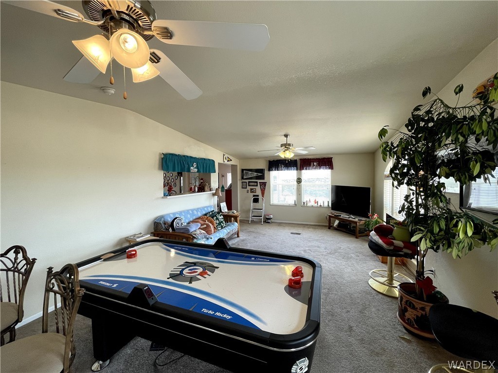 10551 East Blake Ranch Road Kingman, AZ 86401 - Photo 9 of 50 a room with gym equipment and a flat screen tv