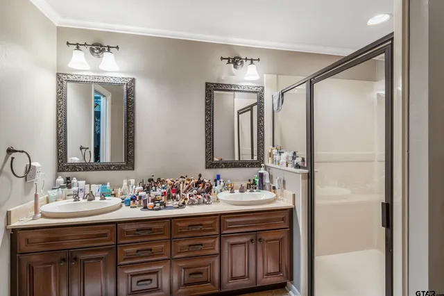 a bathroom with a double vanity sink and a mirror
