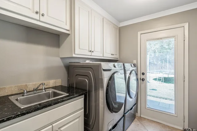 a utility room with sink dryer and washer