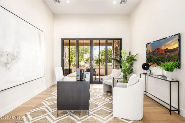 a living room with furniture a fireplace and a flat screen tv