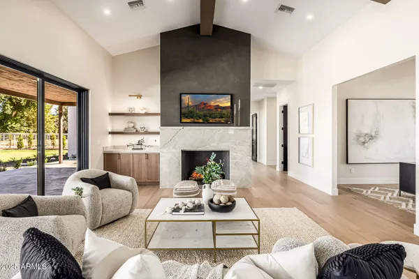a living room with furniture fireplace and flat screen tv