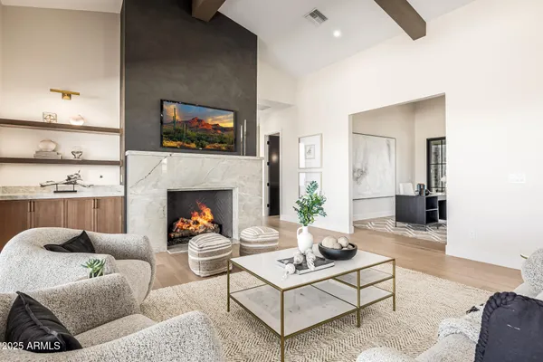 a dining hall with stainless steel appliances kitchen island granite countertop a table chairs and a large window