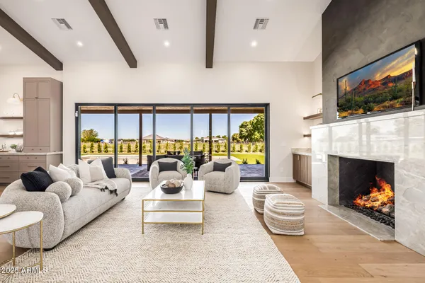 a large kitchen with stainless steel appliances kitchen island granite countertop a large kitchen counter top a stove and a sink with couches