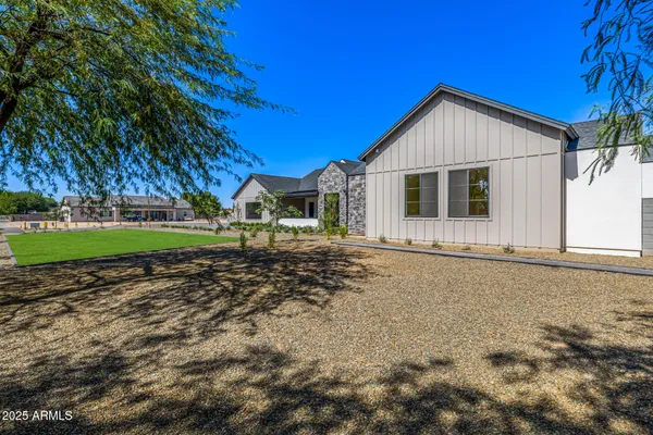 a view of house with backyard and trees