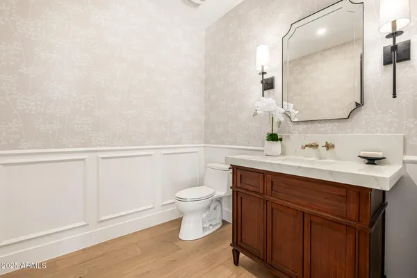 a living room with furniture and paintings on the wall