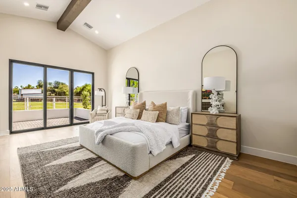 a living room with furniture floor to ceiling window and a flat screen tv