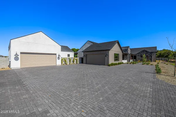 a front view of a house with a garden and yard